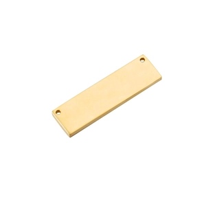 Macro view of a gold-plated rectangular metal pendant with two holes on a white backdrop
