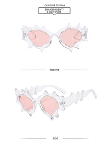 Close-up of futuristic transparent pink punk sunglasses with jagged flame-shaped frames