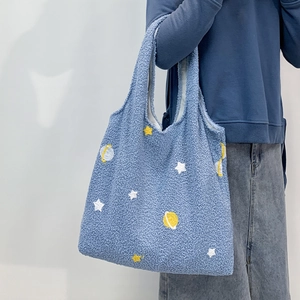 Blue lamb wool tote bag featuring yellow star embroidery and fluffy plush texture