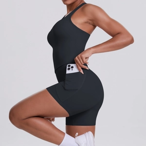 Detail of black athletic romper with side pocket and moisture-wicking stretch fabric