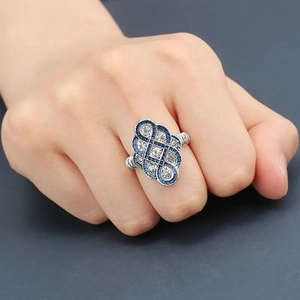 Vintage silver ring with dark blue trapezoid stones and white zircons on hand