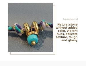Macro view of hand-woven cord necklace with blue natural stone and 18K gold ring detail
