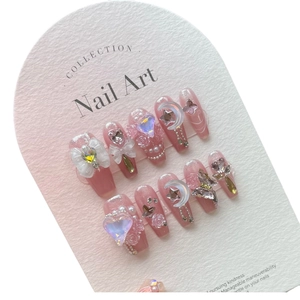 Sweet pink translucent press-on nails with 3D white bows, pearls, and sparkling rhinestones