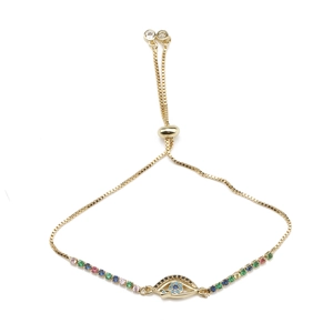 Bracelet œil porte-bonheur doré avec zircons bleus et fermoir coulissant réglable
