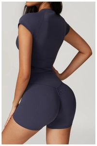 Detail view of high-waist scrunch butt lifting shorts and navy yoga top set