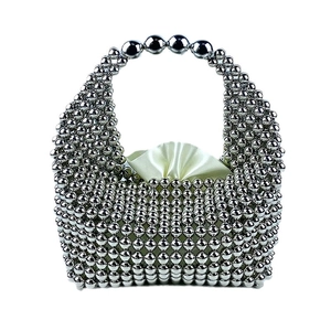 Handcrafted silver beaded pillow bag with top handle and cream satin drawstring lining