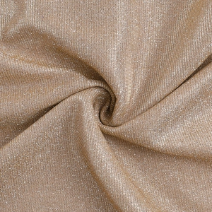 Macro shot of glittering champagne gold fabric with metallic thread and soft textures