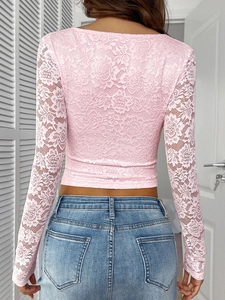 Detailed back view of pink Y2K lace crop top showing intricate floral patterns and fit