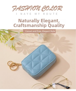 Close-up of sky blue quilted cosmetic bag with gold zipper and mirror inside