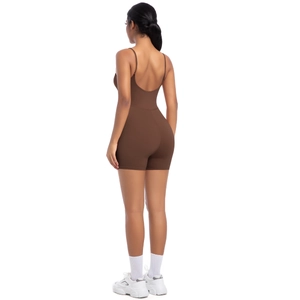 Rear view of brown yoga bodysuit with cross back straps and slim fit shorts