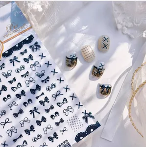 Detail of black and white bow nail art stickers with lace and polka dot patterns