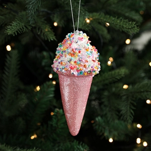 Pink ice cream Christmas tree ornament with colorful sequins and glitter hanging on branch