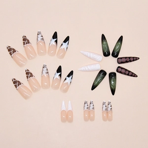 Detail of press on nails featuring zebra patterns and green cat eye finish art