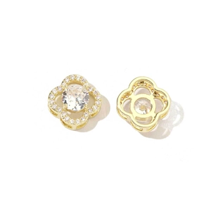 Macro view showing the front and back of gold-plated clover earrings with clear zircon stones