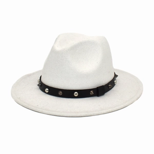Detail of white wide brim felt fedora hat featuring black leather band with silver rivets