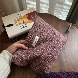 Pink purple tweed woven handbag with simple wish label on a rustic wooden table