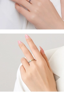Detail of S925 sterling silver rings with colorful drip oil and heart gemstones on hand
