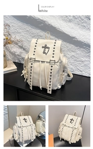 Close-up of white Gothic backpack with metal rivets and silver cross chain detail