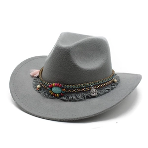 Detail of dark grey felt cowboy hat featuring turquoise stone and bohemian tassel trim