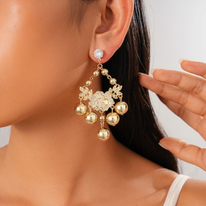 Close-up of gold flower tassel earrings with zircons on model for luxury vintage style