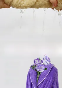 Detail of purple coral fleece bathrobe showing high water absorption and thick soft texture