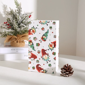 Close-up of Christmas paper gift bag with colorful Nordic gnome print and festive stars
