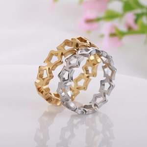Detail of cutout daisy sun flower rings in gold and silver finish on white surface