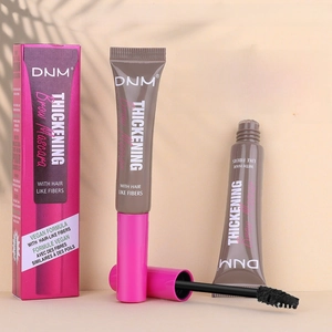 Detail of pink eyebrow glue tube and brush with thickening fiber formula and mascara box