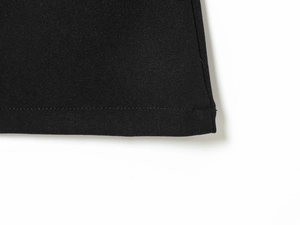 Detail shot of black slim fit top hemline with professional precision stitching