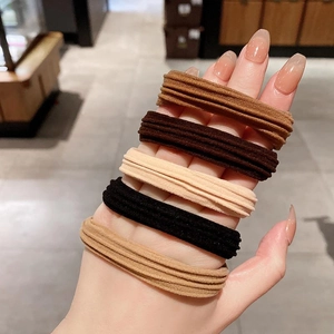 Set of 10 high-elastic earth tone hair ties for ponytails shown on woman's hand