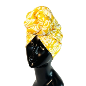Macro shot of faux suede twisted turban headband with yellow and white floral print