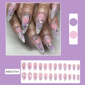 Detail of pink-purple gradient press-on nails with silver metallic accents and 3D pearls