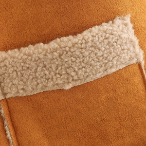 Detailed view of fashionable brown suede and white faux shearling vest fabric texture