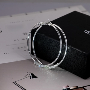 Oversized silver hoop earrings with delicate inlaid crystals and minimalist circular design