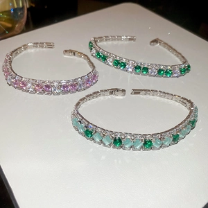 Detailed view of three tennis bracelets with sparkling zircon stones in mixed colors