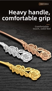 Detail of rose embossed handles on stainless steel spoons with gold and silver finishes