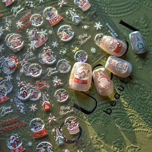 Close-up of 5D embossed Christmas nail stickers with Santa and snow globe patterns