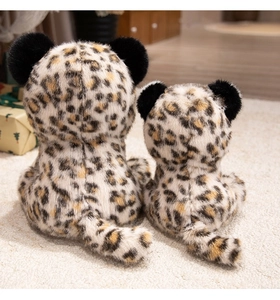 Detailed back view of two soft leopard plush toys showing realistic fur textures and tails