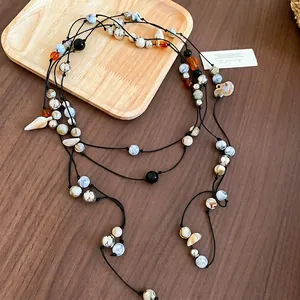 Bohemian multilayer beaded waist chain with shell pendants and marble beads on wood tray