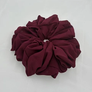 Close-up of wine red chiffon scrunchie showing fabric texture and elastic pleats