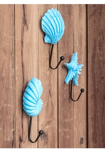 Detail of Mediterranean ocean style iron wall hooks with blue starfish and shell designs