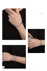 Detail of silver titanium steel Cuban link bracelets with industrial clasp on model