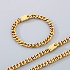 Detailed view of golden Cuban link necklace and bracelet set with sturdy clasp closure