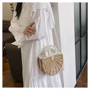 Detail of handmade bamboo bag with pearl beads handle and elegant drawstring lining