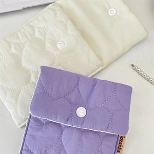 Detailed close-up of quilted heart pattern storage bags with secure snap button closure
