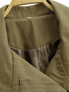 Detail of army green twill jacket neckline with smooth satin lining texture