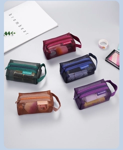 Detailed view of mesh storage bags in five colors with zipper and side handle
