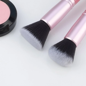 Detailed close-up of premium pink makeup brushes with soft dual-tone synthetic bristles