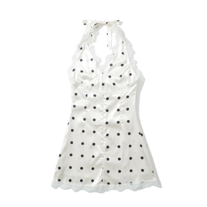 Chic cream white polka dot satin halter dress with delicate lace trim on plain background
