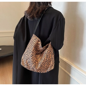 Detailed back view of a soft leopard print canvas tote bag with slim shoulder straps
